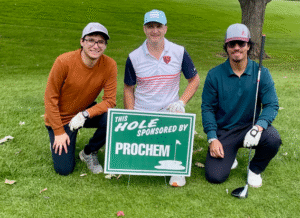 ProChem Inc. Employees pose in front of the hole sponsorship sign at Golf Outing